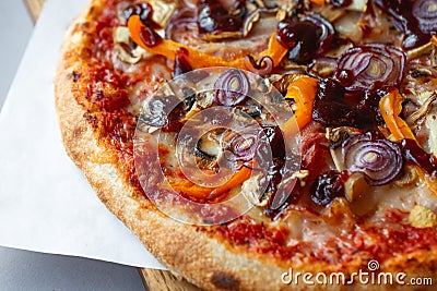 Pizza composition on wooden table with gray background. Stock Photo