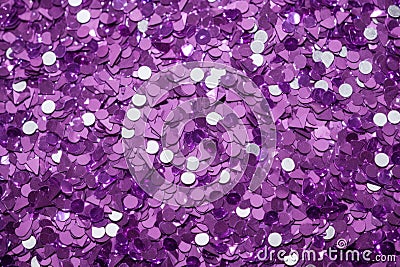 photo of silver glitter scattered on a vibrant purple surface Stock Photo