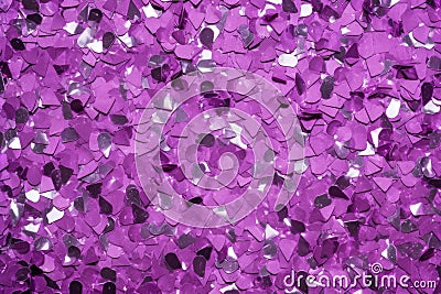 photo of silver glitter scattered on a vibrant purple surface Stock Photo