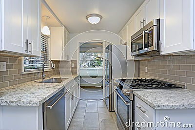 Photo of a small compact kitchen with white shaker cabinets Stock Photo