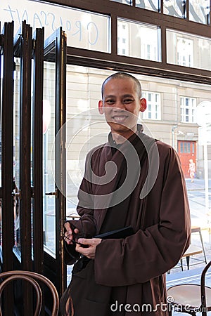 Smiling monk in a restaurant in Prague. Editorial Stock Photo