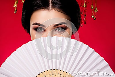 Photo of sophisticated elegant lady hiding face japanese fan traditional isolated on red gradient color background Stock Photo