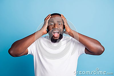 Photo of speechless loser young man open mouth hands head wear white t-shirt over blue background Stock Photo