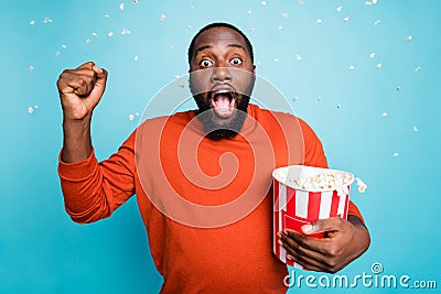 Photo of speechless stunned crazy handsome funny man shocked about plot twist of movie he watches holding bucket Stock Photo