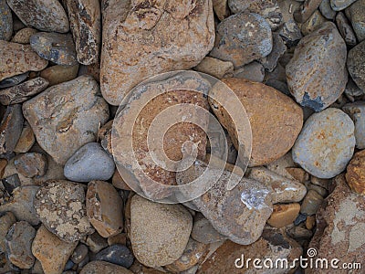 In the photo, stones of different sizes, which succumbed to atmospheric phenomena. Beige and gray tones. Close-up. Macro Stock Photo