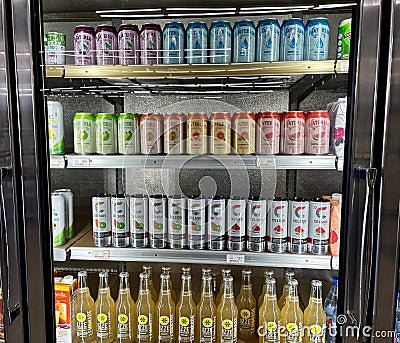 Photo of a store cold fridge door filled with Water Loo, Celsius and Izze Lemonade drinks Editorial Stock Photo