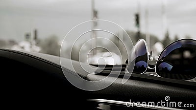 Image of the sunglasses on dashbord in the car Stock Photo