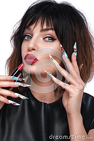 Photo of surprised woman with lipstick in hand in pop art style and design manicure. Creative nails. Stock Photo