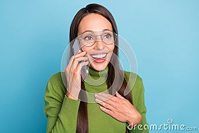 Photo of sweet impressed mature dressed turtleneck spectacles talking gadget looking empty space isolated blue color Stock Photo