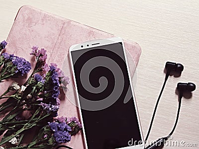 Tablet, phone, headphones and flowers, desktop shot from above Stock Photo