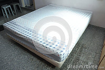 An interior photo of a queen sized bed in a bedroom Stock Photo