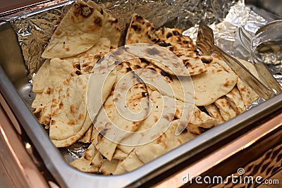 A large open tray of Indian Naan leavened oven baked flatbread Stock Photo