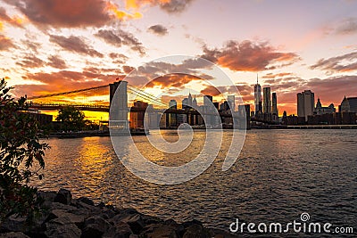 New York Skyline with Brooklyn Bridge Hudson River Manhatten Sun Stock Photo