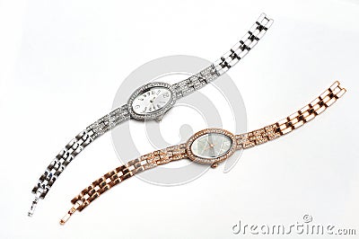 A pair of gold and silver ladies wrist watches with oval watch faces Stock Photo