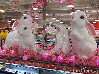 A pair of identical white rabbits replica decorations on display at a supermarket Editorial Stock Photo