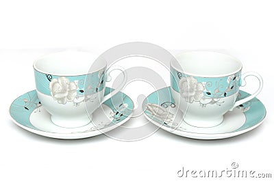 A pair of light colored teacups with saucers Stock Photo