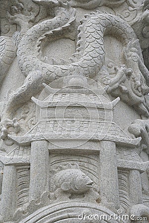 A white washed stone carving of ancient china architecture and an oriental dragon Editorial Stock Photo