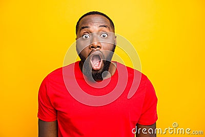 Photo of terrified scared afro american black man afraid of what he sees behind camera while isolated with yellow Stock Photo