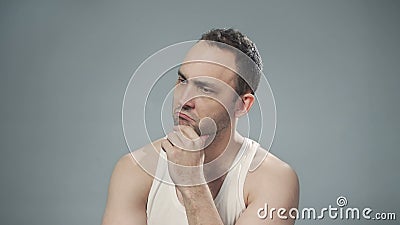 Photo of thinking bristly man on gray background Stock Photo