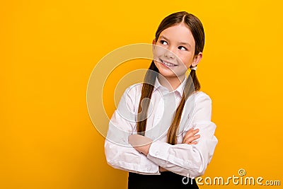 Photo of thoughtful funky preteen schoolkid dressed white shirt arms folded looking empty space yellow color Stock Photo