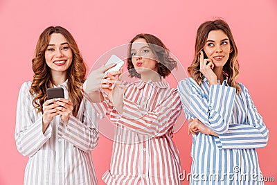 Photo of three gorgeous young girls 20s wearing colorful striped Stock Photo