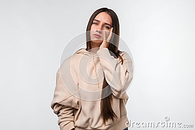 Photo of tired Young brunette woman, covers face, feels fatigue, needs good rest, has sleepy expression Stock Photo