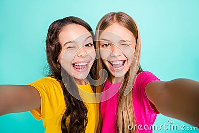 Photo of two casual nice cute excited funny people girls loving taking photos photographing themselves while isolated Stock Photo