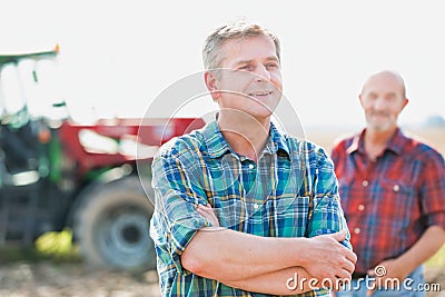 Cropped image of two farmers using digital tablet in field Stock Photo