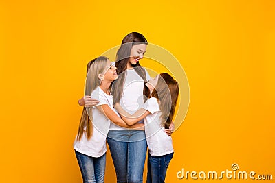 Photo of two little ladies hugging with pretty mommy wear casual outfit isolated yellow background Stock Photo