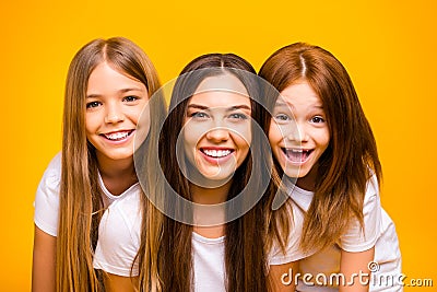 Photo of two little ladies with pretty babysitter wear casual outfit isolated yellow background Stock Photo
