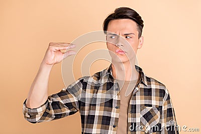 Photo of uncertain unsure suspicious guy look side talk hand wear plaid shirt isolated beige color background Stock Photo