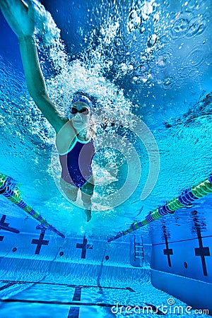 Underwater shot of woman swimming in pool Stock Photo