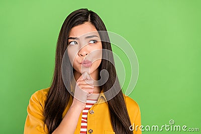Photo of unsure brown hairdo young lady look empty space wear yellow shirt isolated on green color background Stock Photo