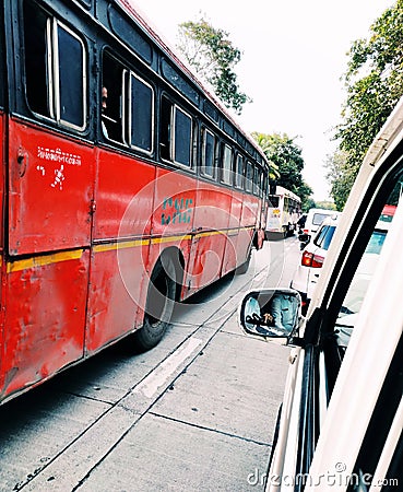 A view of red bus taken in traffic Editorial Stock Photo