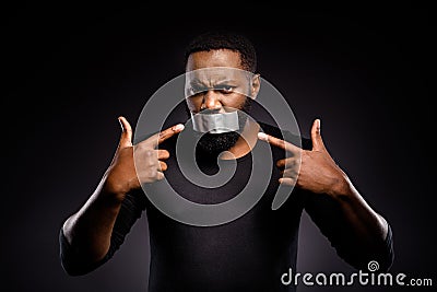 Photo of voiceless speechless afro american guy close cover adhesive tape lips point index finger suffer silence no Stock Photo