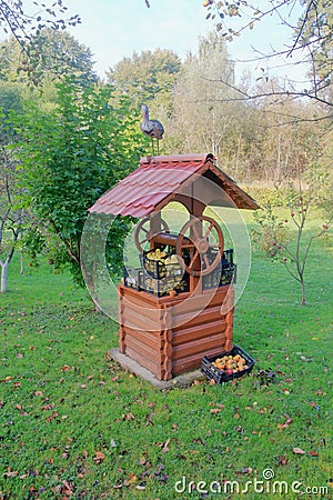 Harvest of apples laid on a well in the garden Stock Photo