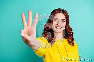 Photo of wavy curly charming fascinating gorgeous girlfriend smiling toothily showing you three fingers sign isolated Stock Photo