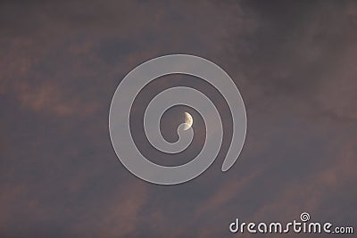 Photo of a Waxing Crescent Half Moon in the Clouds Stock Photo