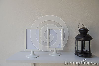 Photo White Frame on a wooden and Lantern on wall background . Stock Photo