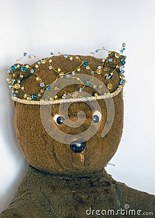 Photo of a 45-year-old bear with a homemade pearl crown on his head,handmade Stock Photo