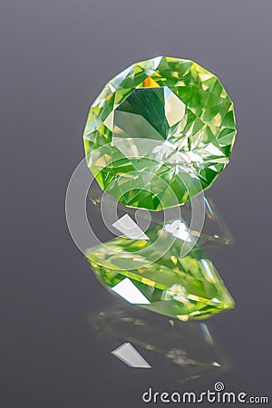 Photo of a Yellow-green-chrysolite colored Spinel gemstone, cut in the shape of a Standard Round Brilliant SRB with star design Stock Photo