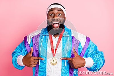 Photo of young african man happy positive smile point fingers golden medal victory sporty isolated over pink color Stock Photo