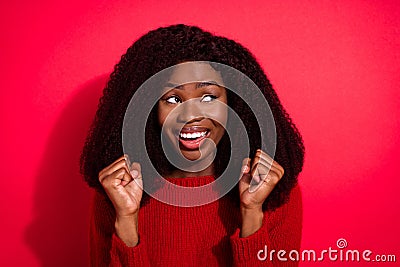 Photo of young afro woman happy positive smile rejoice victory fists hands lucky look empty space isolated over red Stock Photo