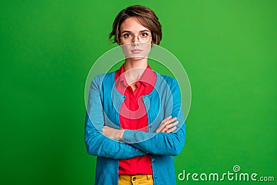 Photo of young attractive girl confident serious crossed arms isolated over vivid green color background Stock Photo