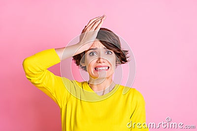 Photo of young attractive unhappy upset scared worried girl made mistake hold hand on forehead isolated on yellow color Stock Photo