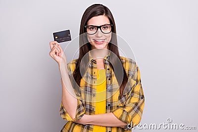 Photo of young attractive woman happy positive smile hold credit card money isolated over grey color background Editorial Stock Photo