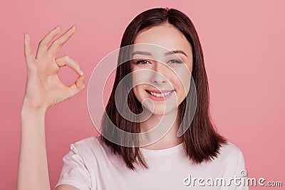 Photo of young attractive woman happy positive smile show okay alright sign great isolated over pink color background Stock Photo