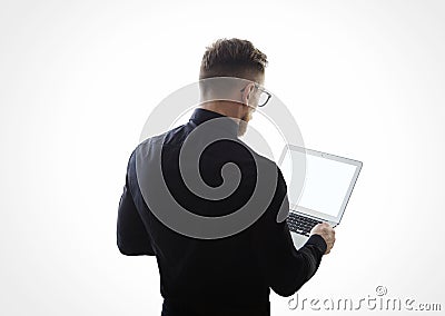 Photo of young bearded businessman wearing black shirt and holding contemporary notebook hands. White empty screen ready for you m Stock Photo