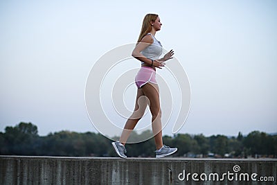 Young fitness girl brisk walking Stock Photo