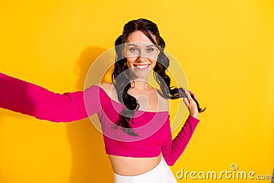 Photo of young cheerful girl happy positive smile make selfie summer trip blogger isolated over yellow color background Stock Photo